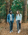 Man wearing MOVE Sport Apparel men’s Essential Jogger beside a woman on an autumn woodland path.