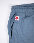 Rear pocket and original red-and-white embellishment on Blue Mirage MOVE Sport Apparel men’s Essential Jogger.