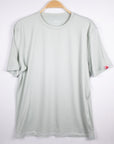 MOVE Sport Apparel men’s Essential Short Sleeve: Heather Aqua Glass shirt shown from the front on a hanger.