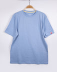 MOVE Sport Apparel men’s Essential Short Sleeve: Heather Chambray Blue shirt hanging against a pale background.