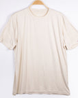MOVE Sport Apparel men’s Essential Short Sleeve: Heather Sand shirt shown from the front on a hanger.