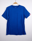 MOVE Sport Apparel men’s Essential Short Sleeve: Surf the Web blue shirt hanging against a pale background.