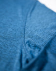 Close view of the heathered fabric and stitching on the Blue Mirage MOVE Sport Apparel Men’s Essential Long Sleeve.