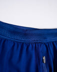 MOVE sport apparel men's blue running shorts featuring a breathable mesh waistband and a secure zippered pocket.