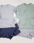 MOVE sport apparel long sleeve shirts and athletic shorts in grey, sage green, and navy blue on a neutral background