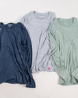 MOVE sport apparel Women's Essential long sleeve shirts in navy, light grey, and sage green with subtle branding.