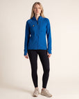 A model wearing a MOVE sport apparel blue waffle-knit full-zip hoodie with raglan sleeves and black leggings.