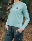 MOVE sport apparel long sleeve crewneck sweatshirt in heathered teal with side-slit hem and signature logo patch