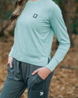 MOVE sport apparel long sleeve crewneck sweatshirt in light teal with side slits and signature logo patch