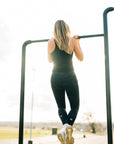 MOVE Sport Apparel women’s 25-Inch Running Tights: Woman wearing Black Camouflage tights during an outdoor pull-up.