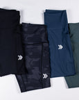 MOVE Sport Apparel women’s 25-Inch Running Tights: Black, Black Camouflage, Pageant blue and Balsam Green color options arranged together.