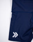 Close view of the original silver double-chevron embellishment near the hem of Maritime Blue MOVE Sport Apparel Women’s Biker Shorts.