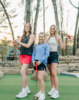 MOVE Sport Apparel women’s Black Label Lightweight Sun Hoodie: Woman wearing Deep Periwinkle sun hoodie with friends at a miniature golf course.