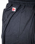 Black Essential Joggers pocket opening with the original white tab and red double chevrons.