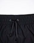 Close-up of black skort waistband stitching, eyelets and drawstring.