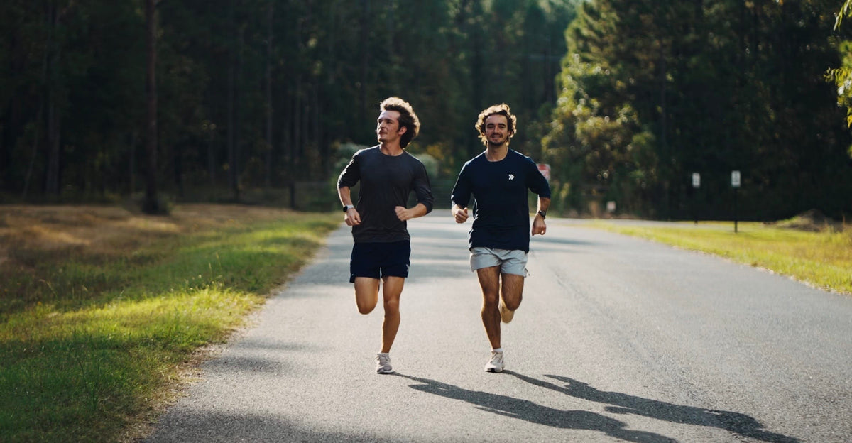 Two runners training on a sunny Louisiana road in MOVE Sport Apparel