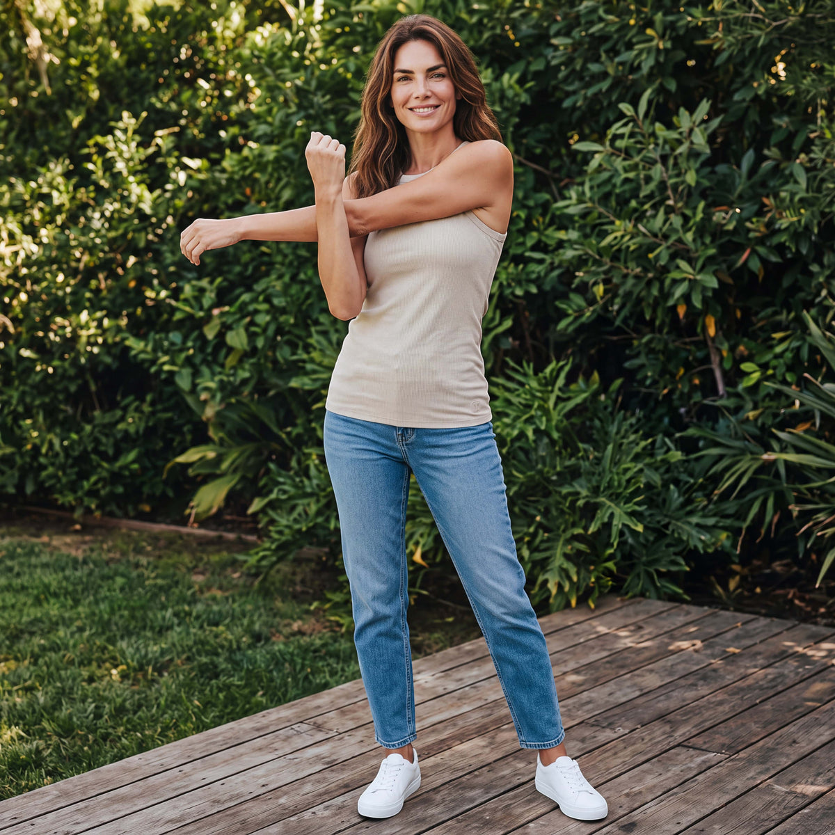 MOVE Sport Apparel Bamboo Full Length Tank Top in Pistachio Shell, worn by an adult woman stretching on a garden terrace.