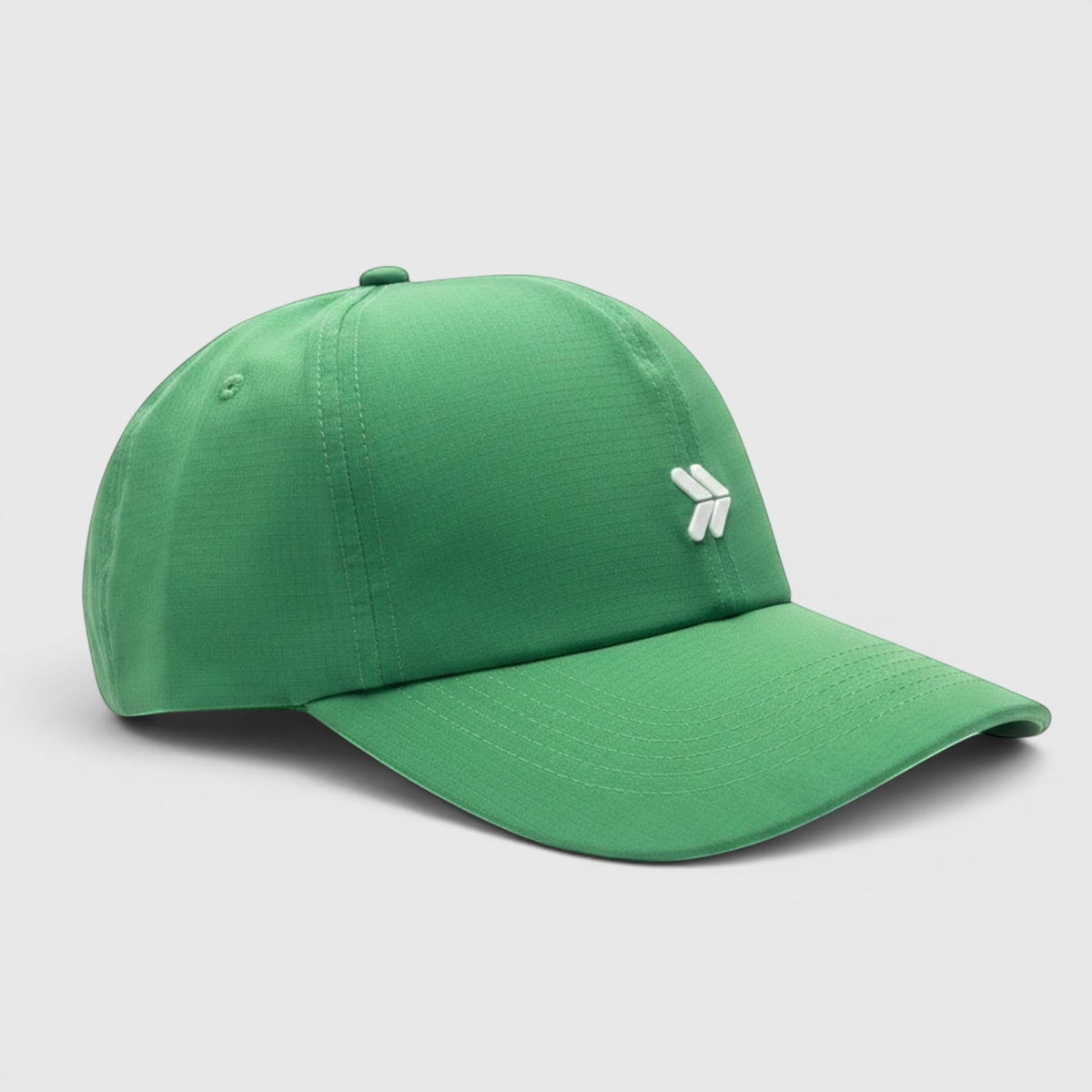 Three-quarter view of the Kelly Green Logo Hat with curved brim and original white chevron embellishment.