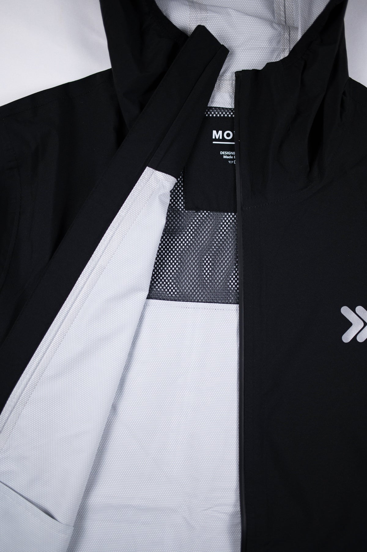 Black MOVE Sport Apparel women’s AquaLight jacket showing white mesh lining and front zipper.