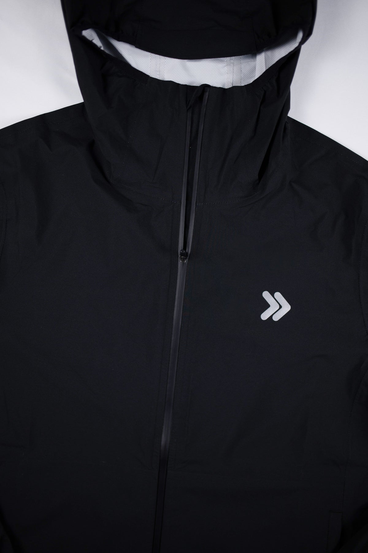 Original garment detail of the black MOVE Sport Apparel women’s AquaLight Packable Jacket.