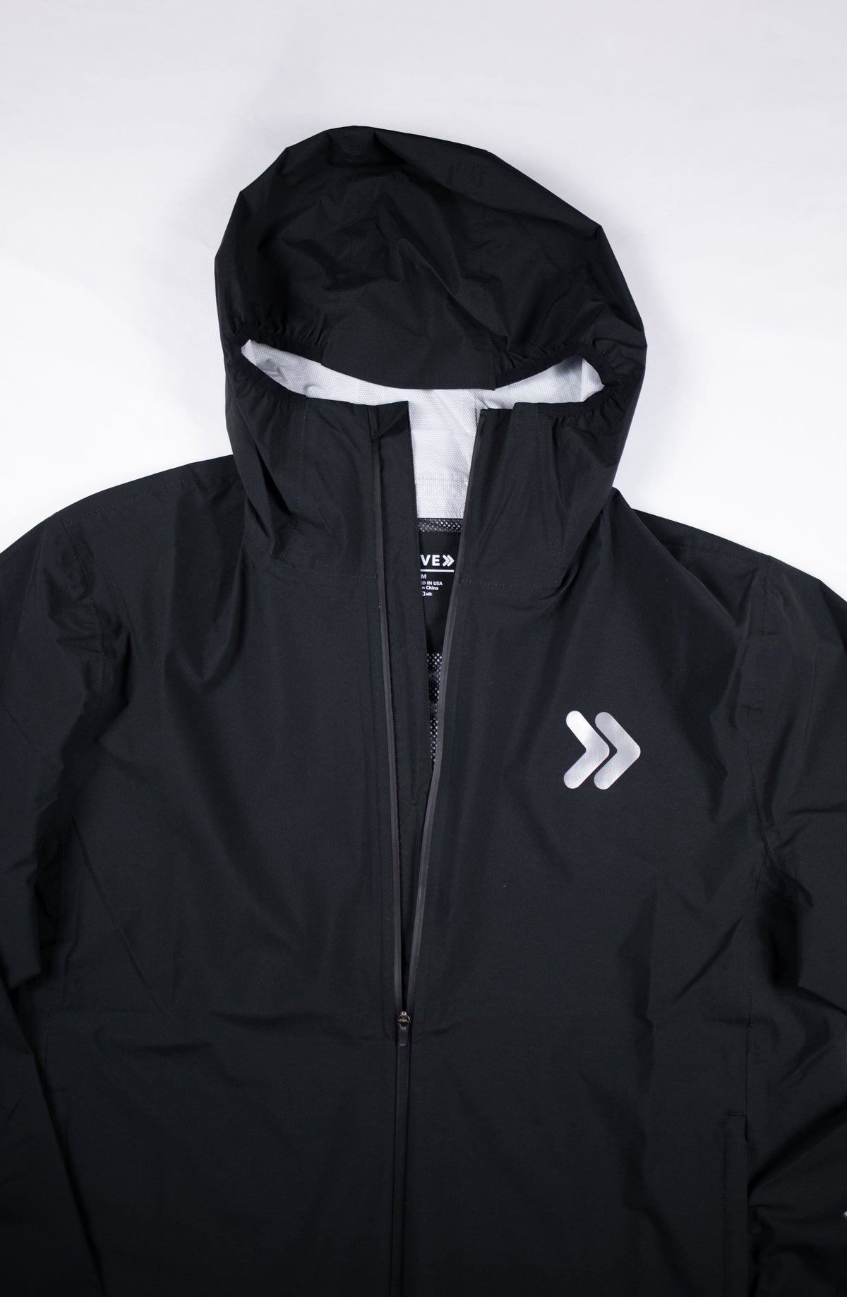 Black MOVE Sport Apparel men’s AquaLight jacket showing hood and original chest embellishment.