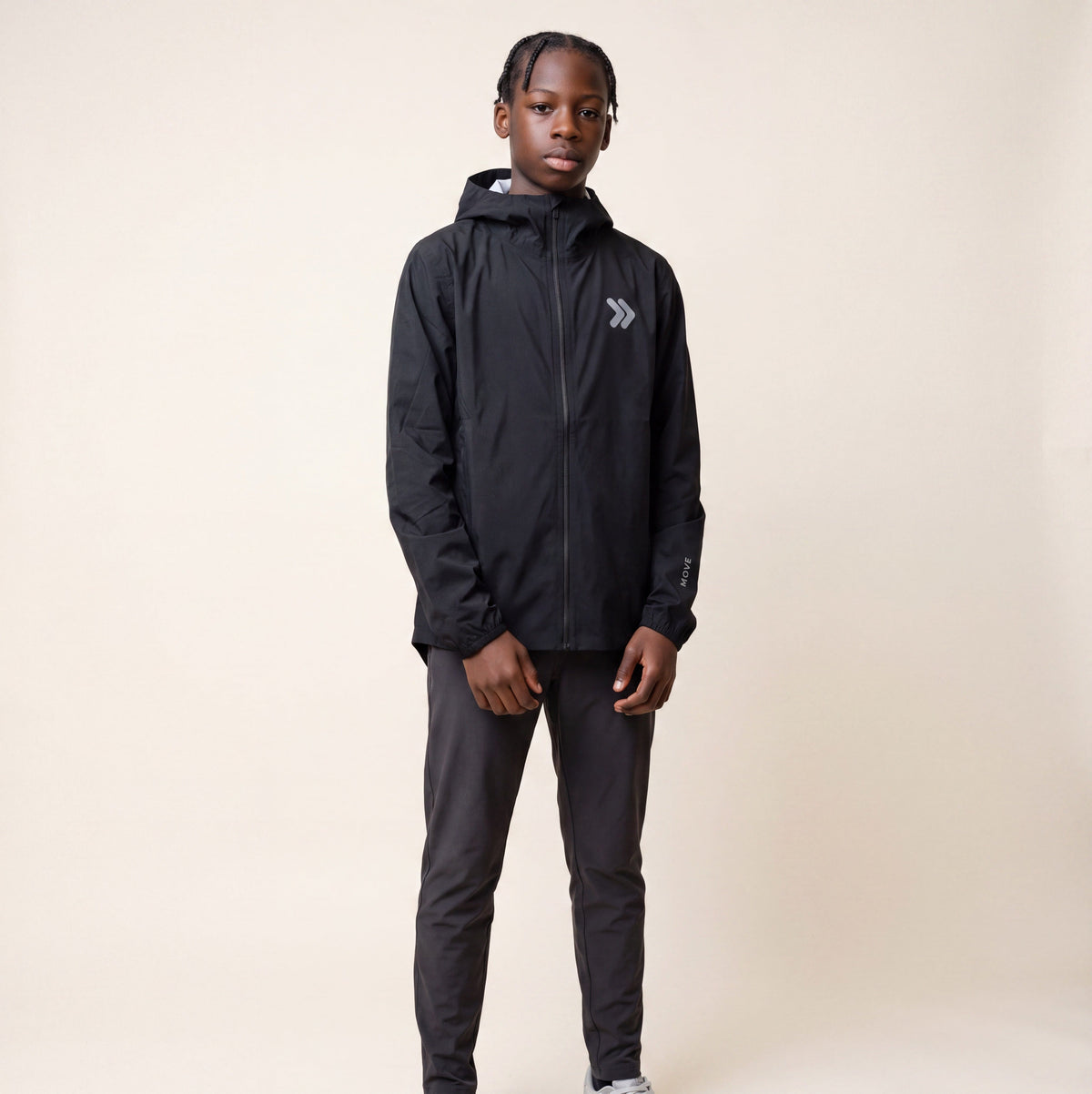 Studio model wearing the black MOVE Sport Apparel men’s AquaLight Packable Jacket.