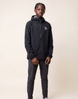 Studio model wearing the black MOVE Sport Apparel men’s AquaLight Packable Jacket.
