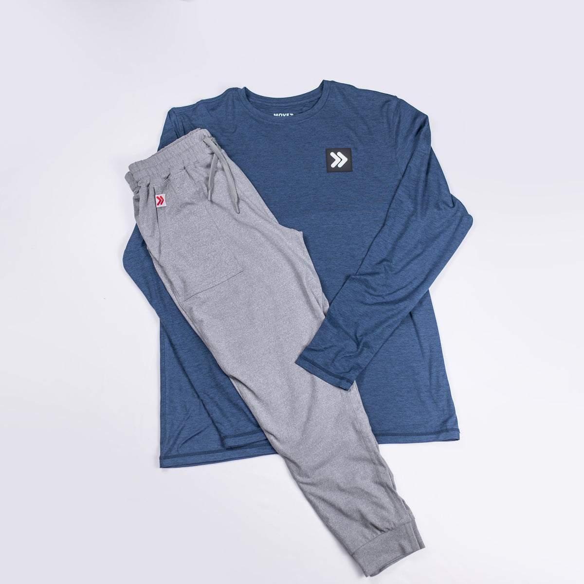 Pageant Blue Black Label long sleeve top paired with grey trousers, showing original chest embellishment.