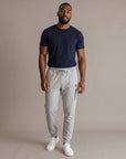 Man modeling MOVE Sport Apparel Men’s Essential Jogger Black Label in Silver Cloud in a neutral studio.
