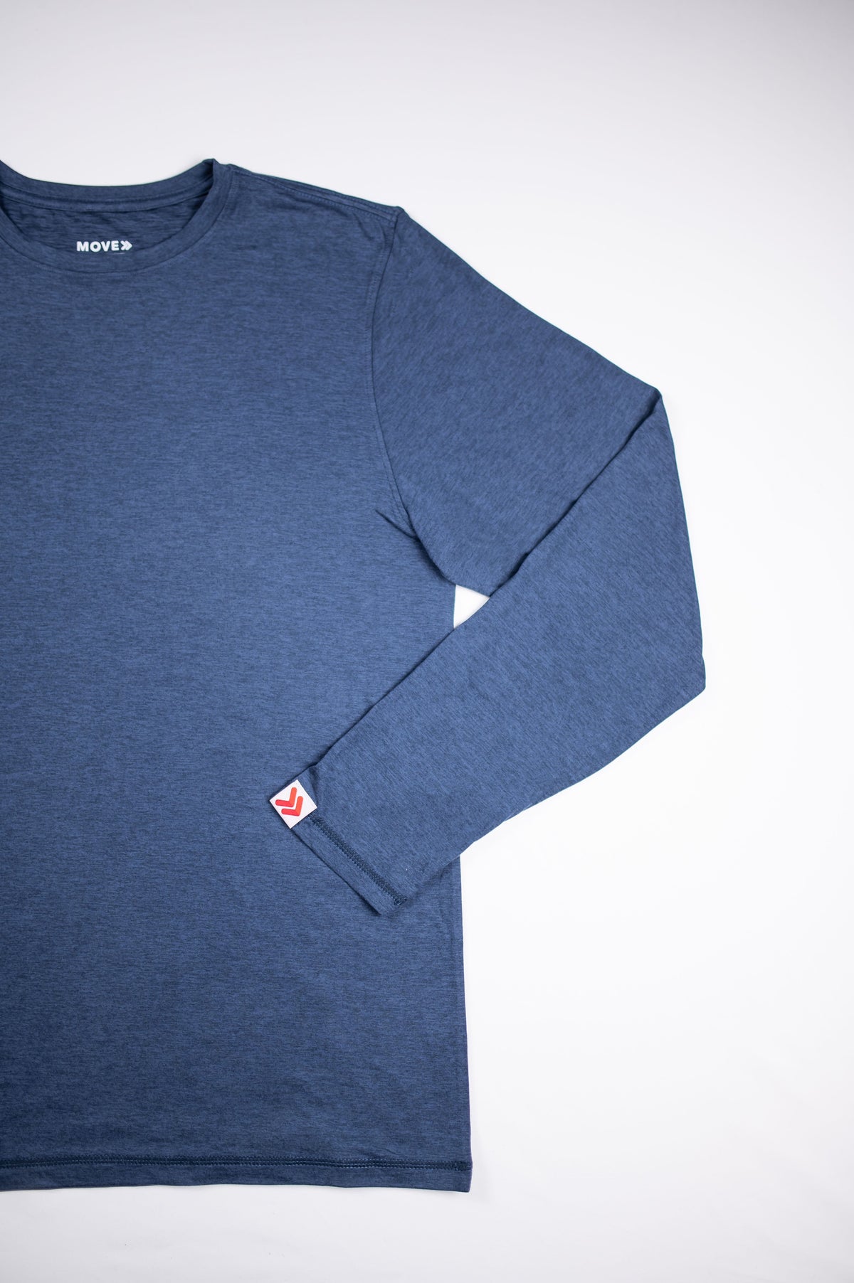 Front flat-lay view of the MOVE Sport Apparel Men’s Essential Long Sleeve in Blue Mirage with one sleeve folded across the shirt.