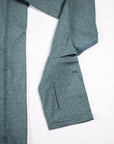 Close view of the Balsam Green Essential Quarter Zip Pro sleeve cuff and thumb opening.