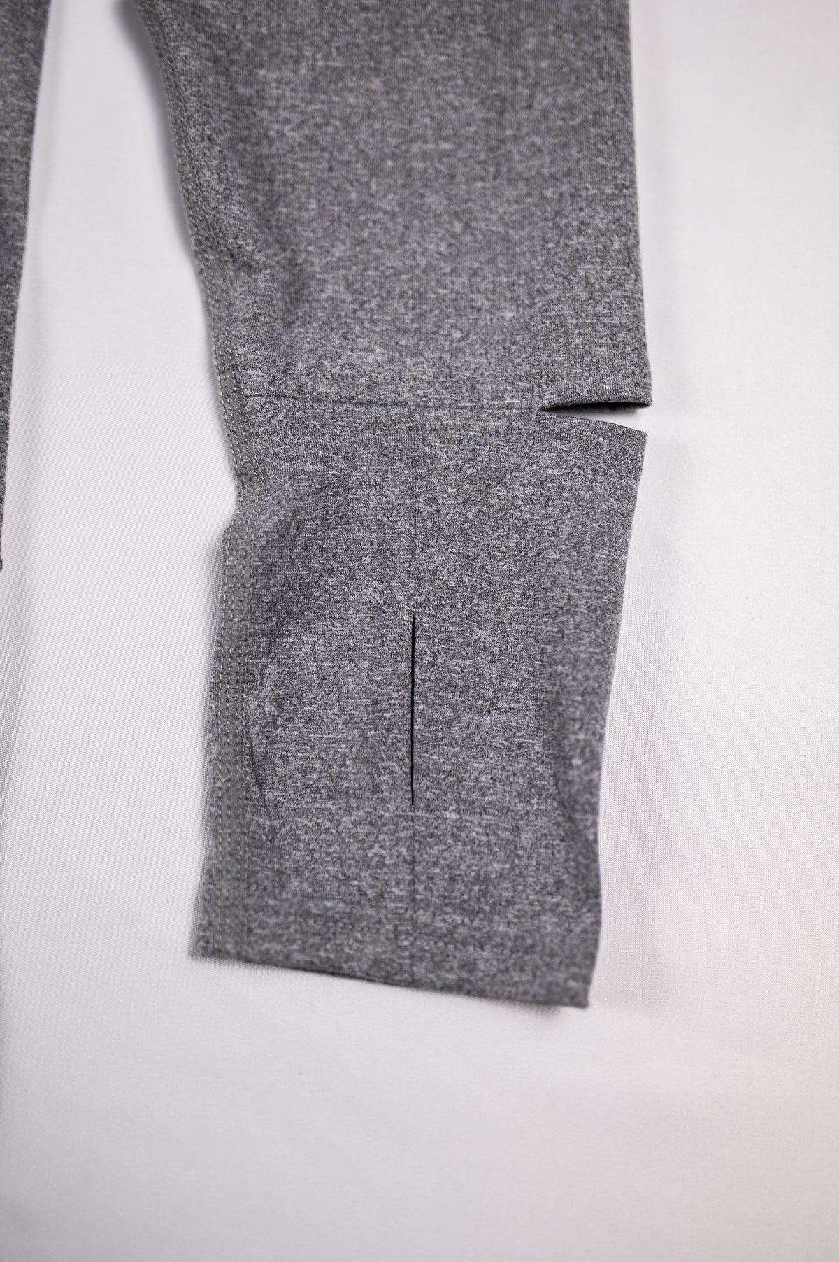 Close view of the Heather Classic Gray Essential Quarter Zip Pro sleeve cuff and thumb opening.