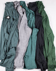 Five MOVE Sport Apparel men’s Essential Quarter Zip Pro colors arranged together, showing original collars, chest patches and sleeve pockets.