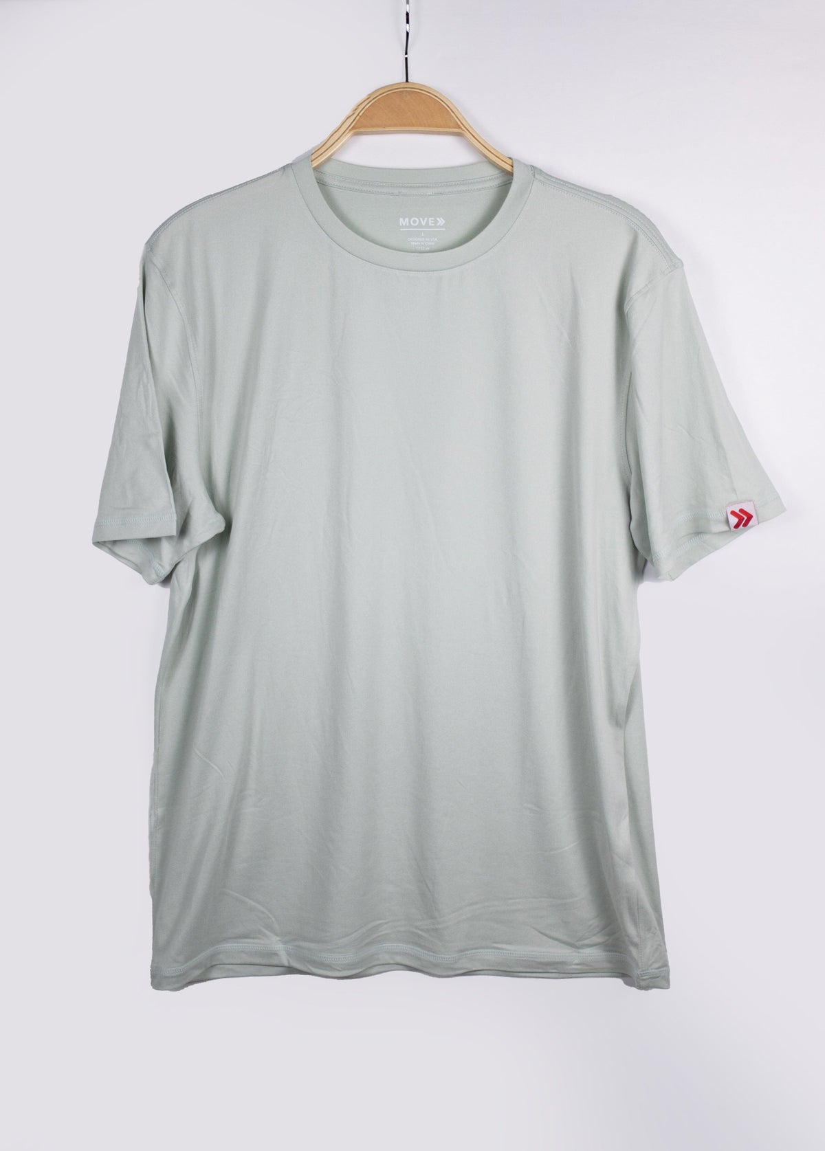 MOVE Sport Apparel men’s Essential Short Sleeve: Heather Aqua Glass shirt hanging against a pale background.