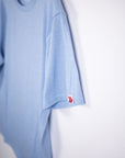 MOVE Sport Apparel men’s Essential Short Sleeve: Heather Chambray Blue shirt showing its original sleeve tab.