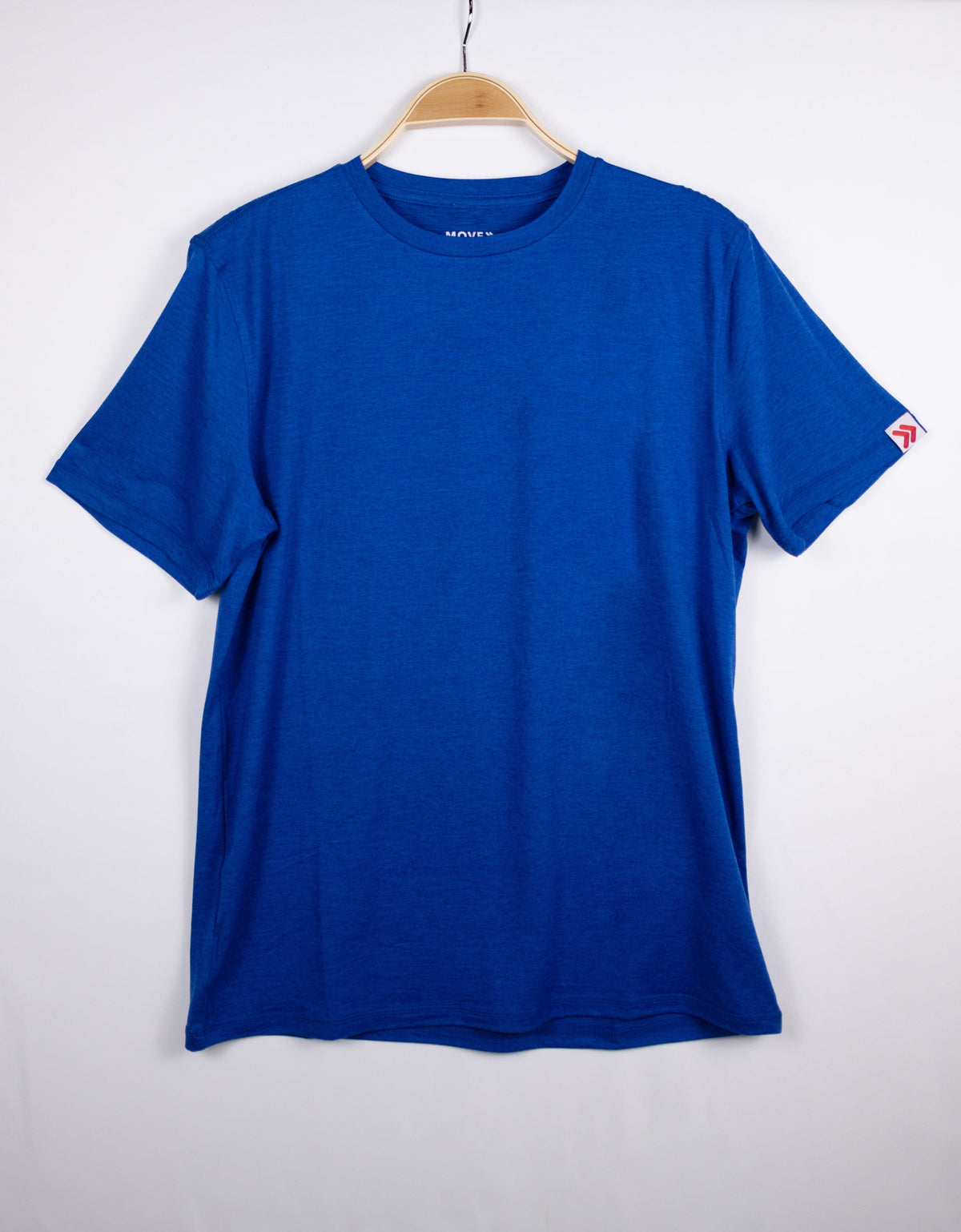 MOVE Sport Apparel men’s Essential Short Sleeve: Surf the Web blue shirt hanging against a pale background.