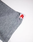 Ultimate Gray LuxDry tee sleeve hem and original white tab with red double chevrons.
