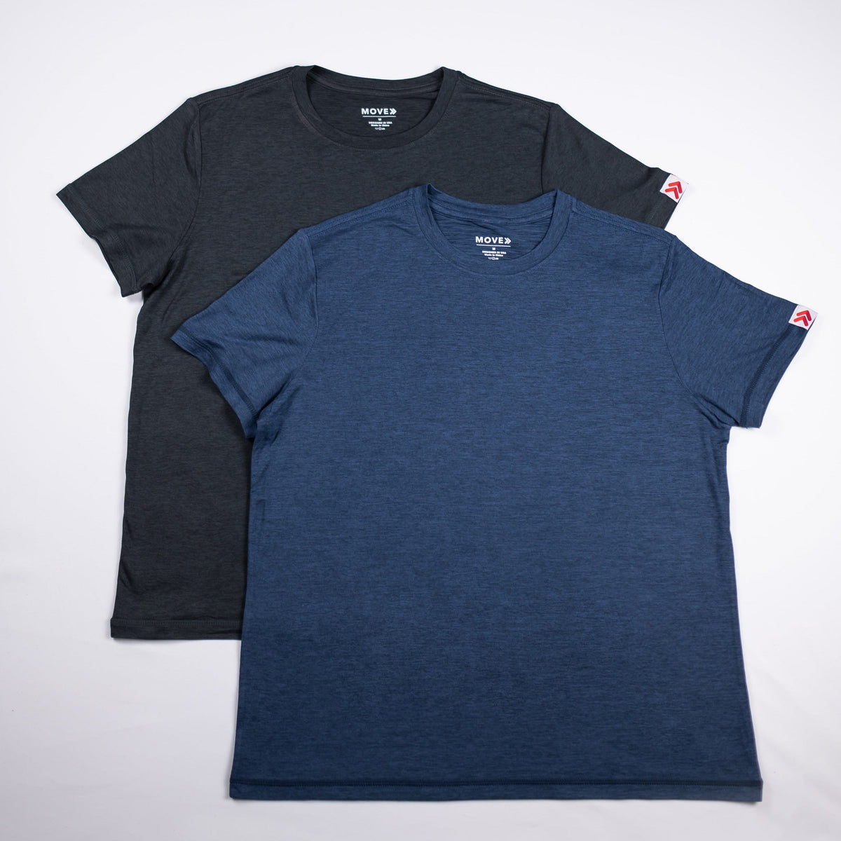 Asphalt charcoal and Midnight Sail blue merino tees arranged together from the front.