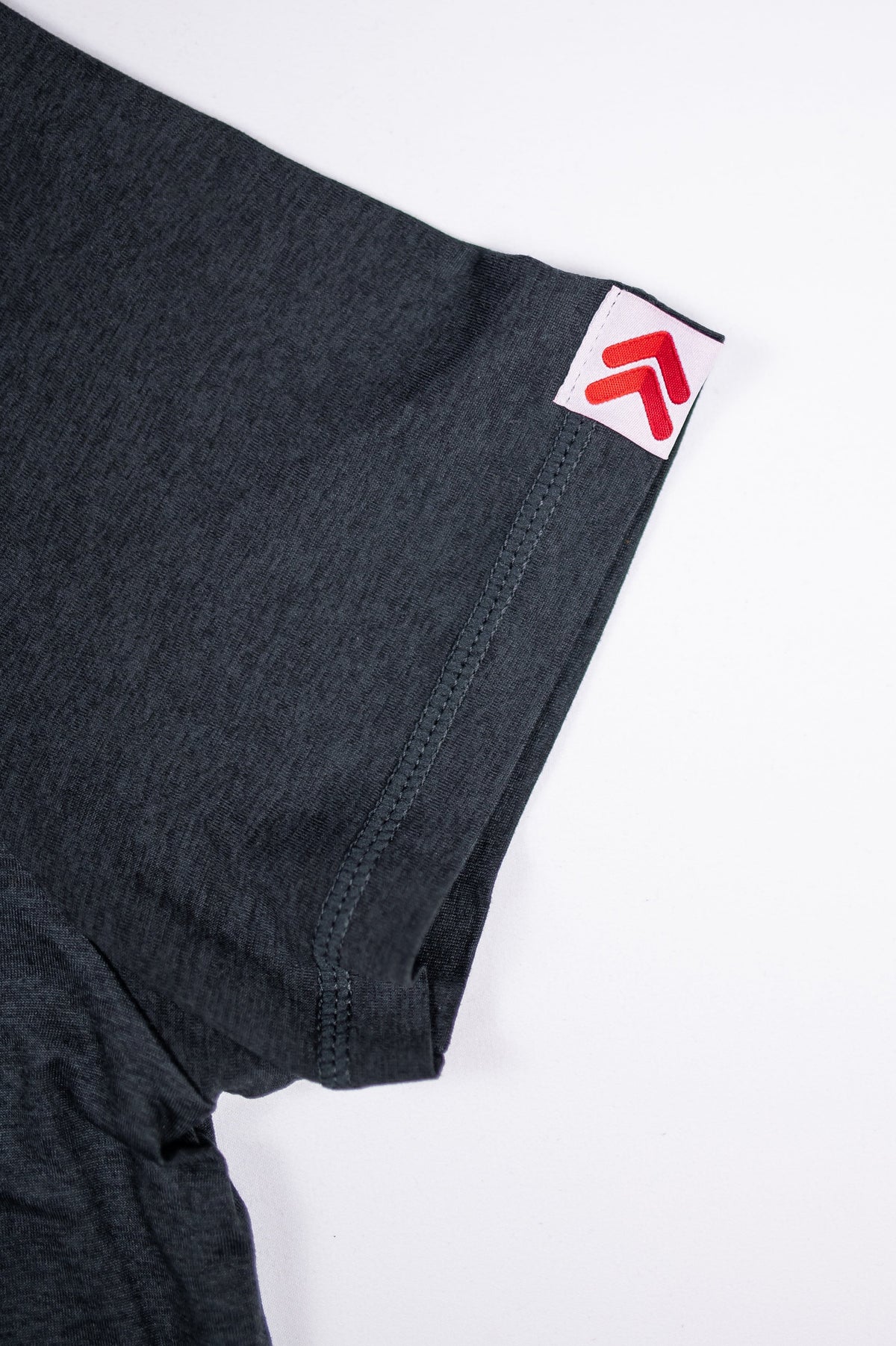 Asphalt merino tee sleeve stitching and original white tab with red double chevrons.