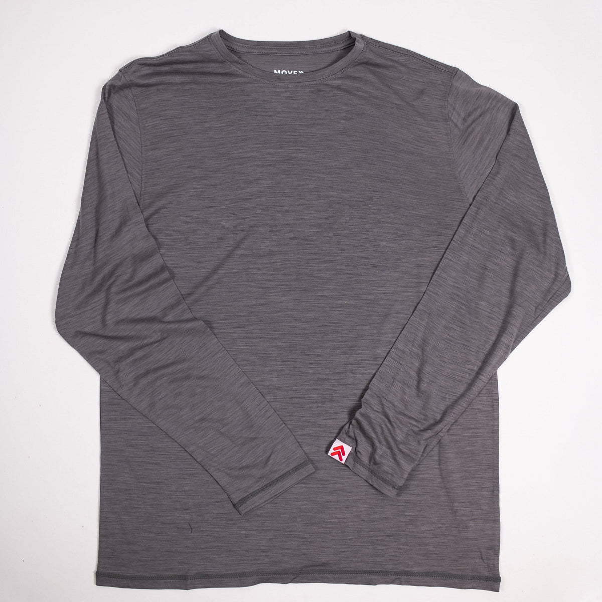 MOVE sport apparel heathered grey merino wool long sleeve crew neck shirt with a signature brand tab on the cuff.