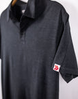 MOVE sport apparel Essential Polo Shirt in charcoal grey moisture-wicking fabric with a small red logo on the sleeve