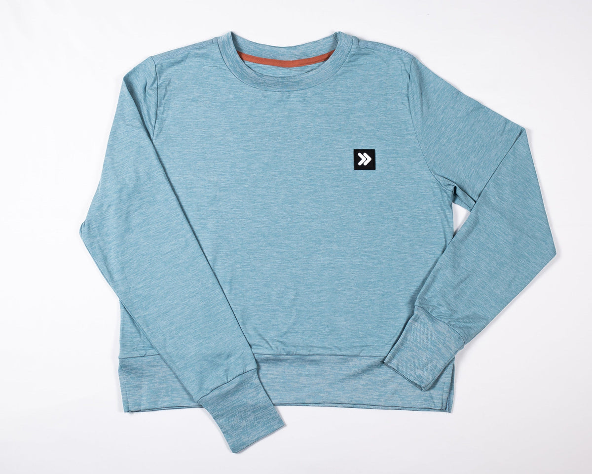 MOVE sport apparel women's heathered blue long sleeve crewneck sweatshirt with ribbed cuffs and side-slit hem.
