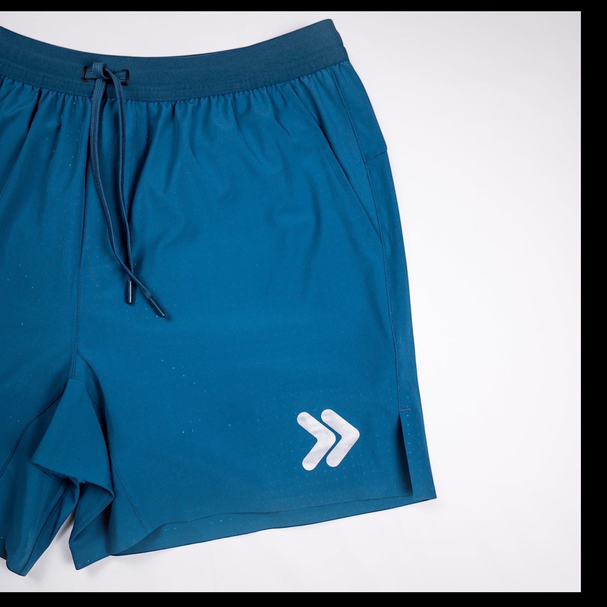 MOVE sport apparel Agility 6 inch training shorts in deep blue with a drawstring waist and reflective logo detail
