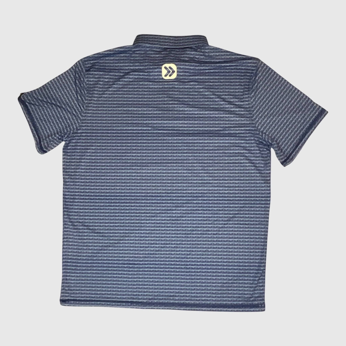 MOVE Sport Apparel Men’s Clubhouse Golf Polo in Water Hazard navy print, back view with original upper-back embellishment.