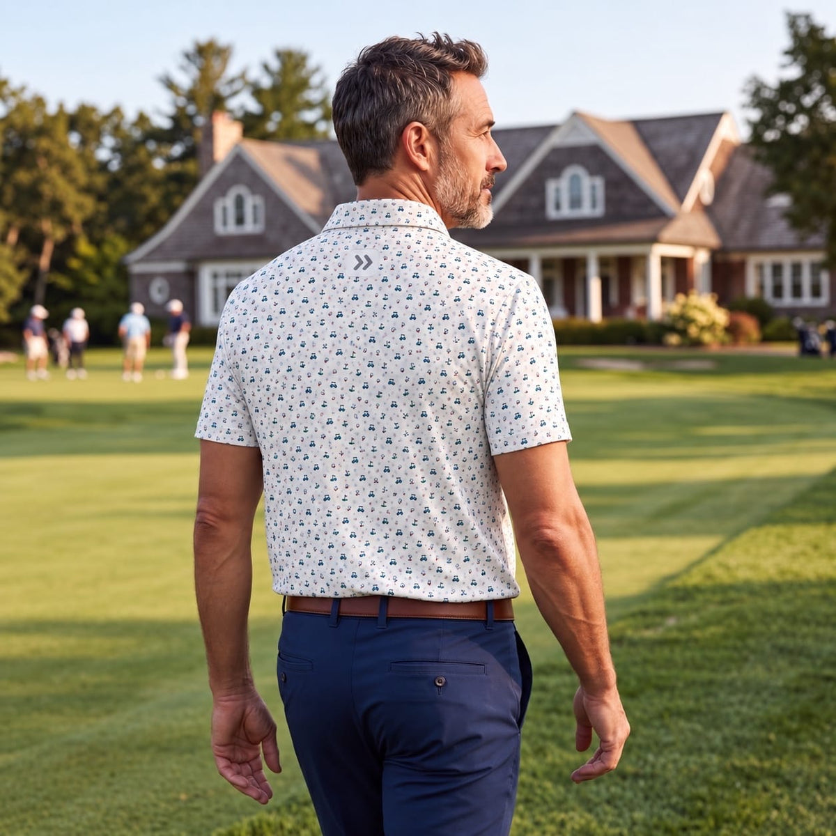 MOVE Sport Apparel Men’s Clubhouse Golf Polo in On Par print, back view worn by an adult man on a golf course.