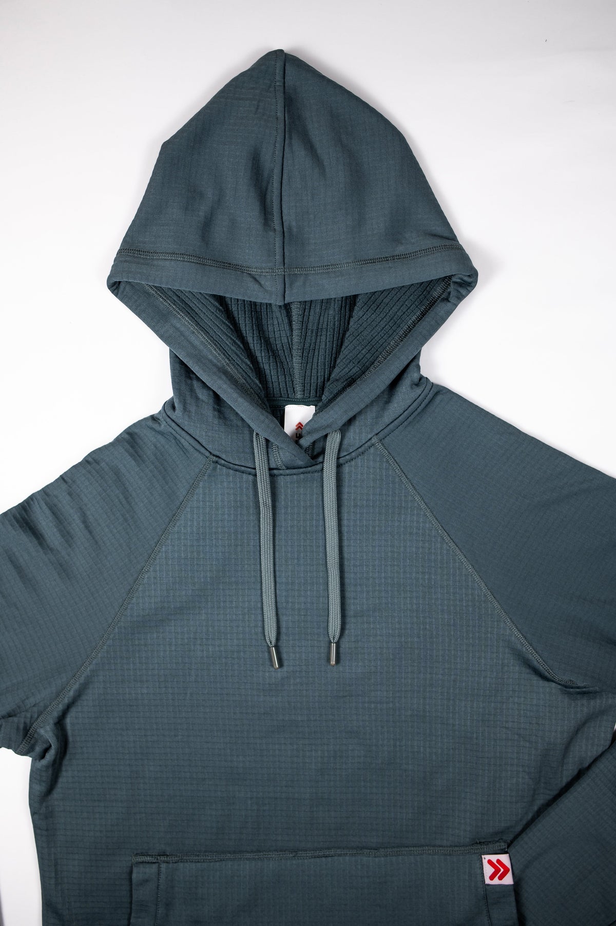 Blue Heather Ashes MOVE Sport Apparel men’s waffle hoodie showing the textured knit, drawstring hood, raglan seams, kangaroo pocket and red-and-white pocket logo.