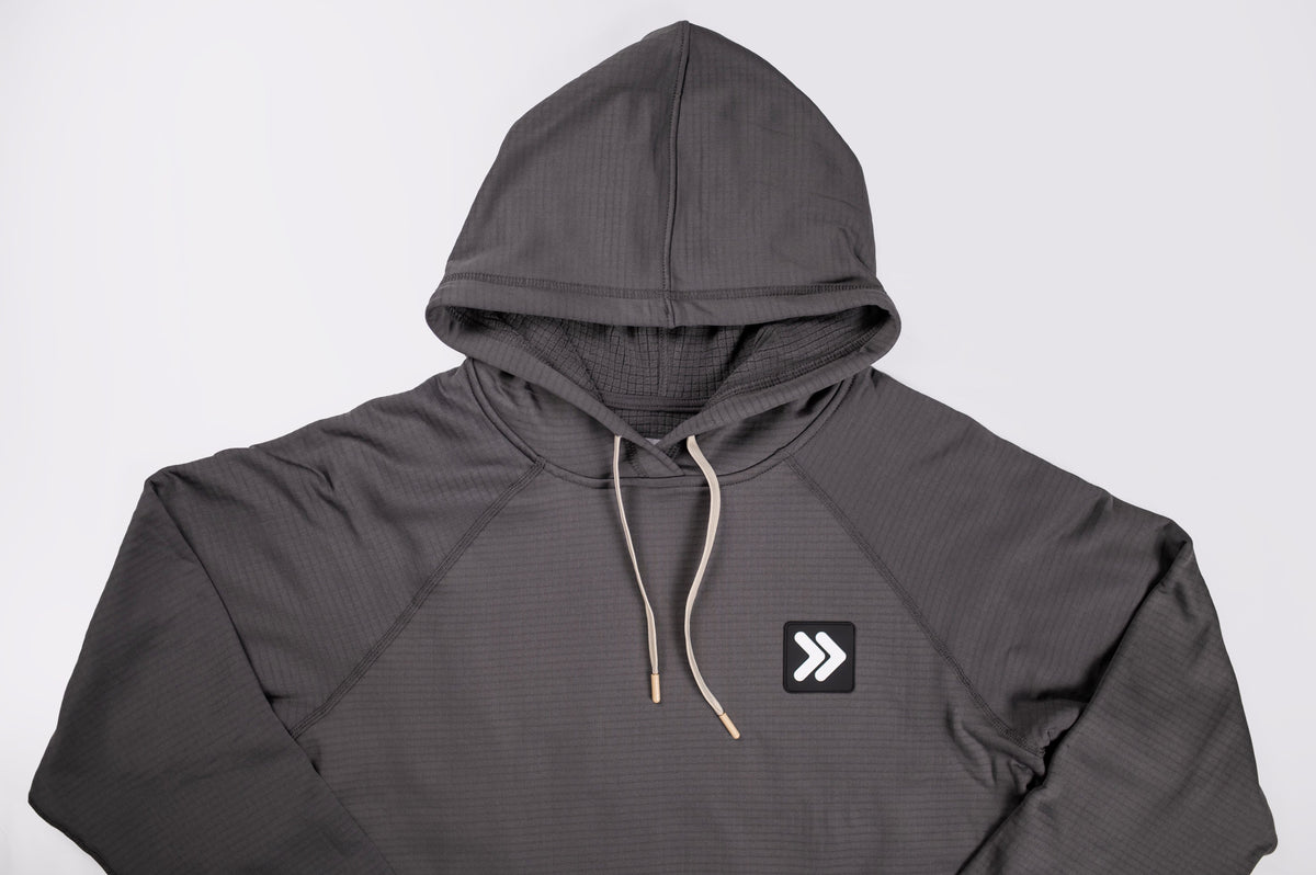MOVE sport apparel charcoal grey waffle-knit hoodie with an adjustable hood, raglan sleeves, and chest logo patch.