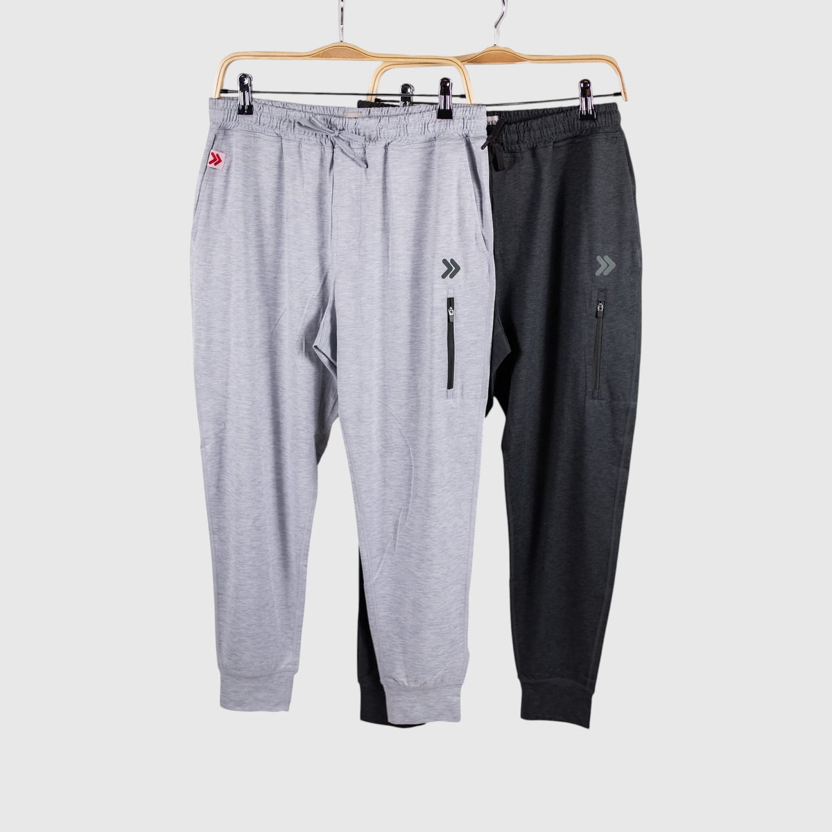 MOVE Sport Apparel Men’s Essential Jogger Black Label in Silver Cloud and Heather Black on hangers.