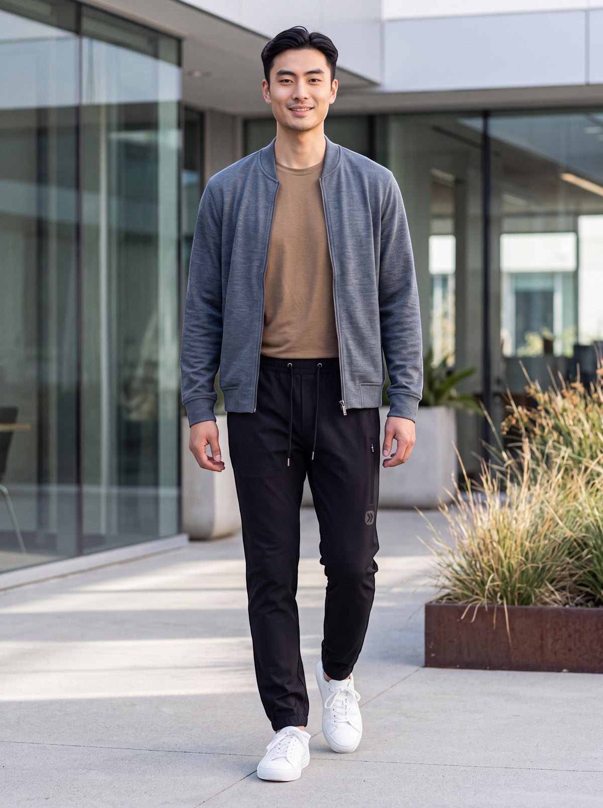 Man wearing MOVE Sport Apparel Men’s Ripstop 5 pocket Joggers in Black outside a modern building.