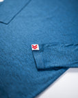 Close view of the red-and-white cuff label and fabric texture on the Blue Mirage MOVE Sport Apparel Men’s Essential Long Sleeve.